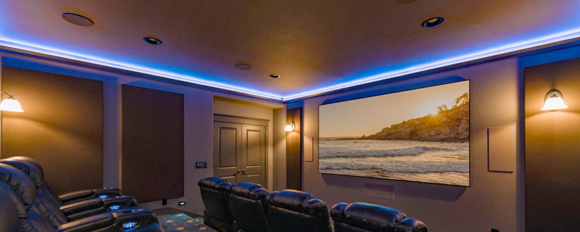 Large screen media room with projector, designed and installed by Home Systems