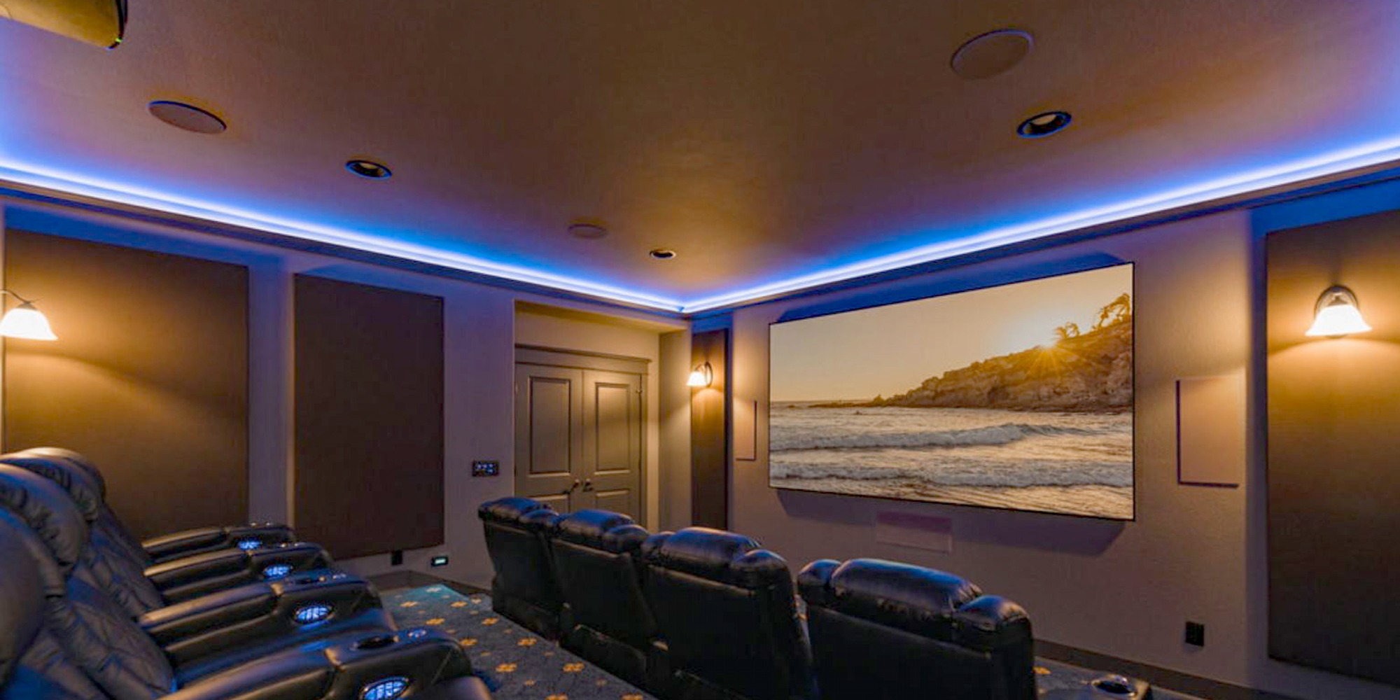 Large screen media room with projector, designed and installed by Home Systems